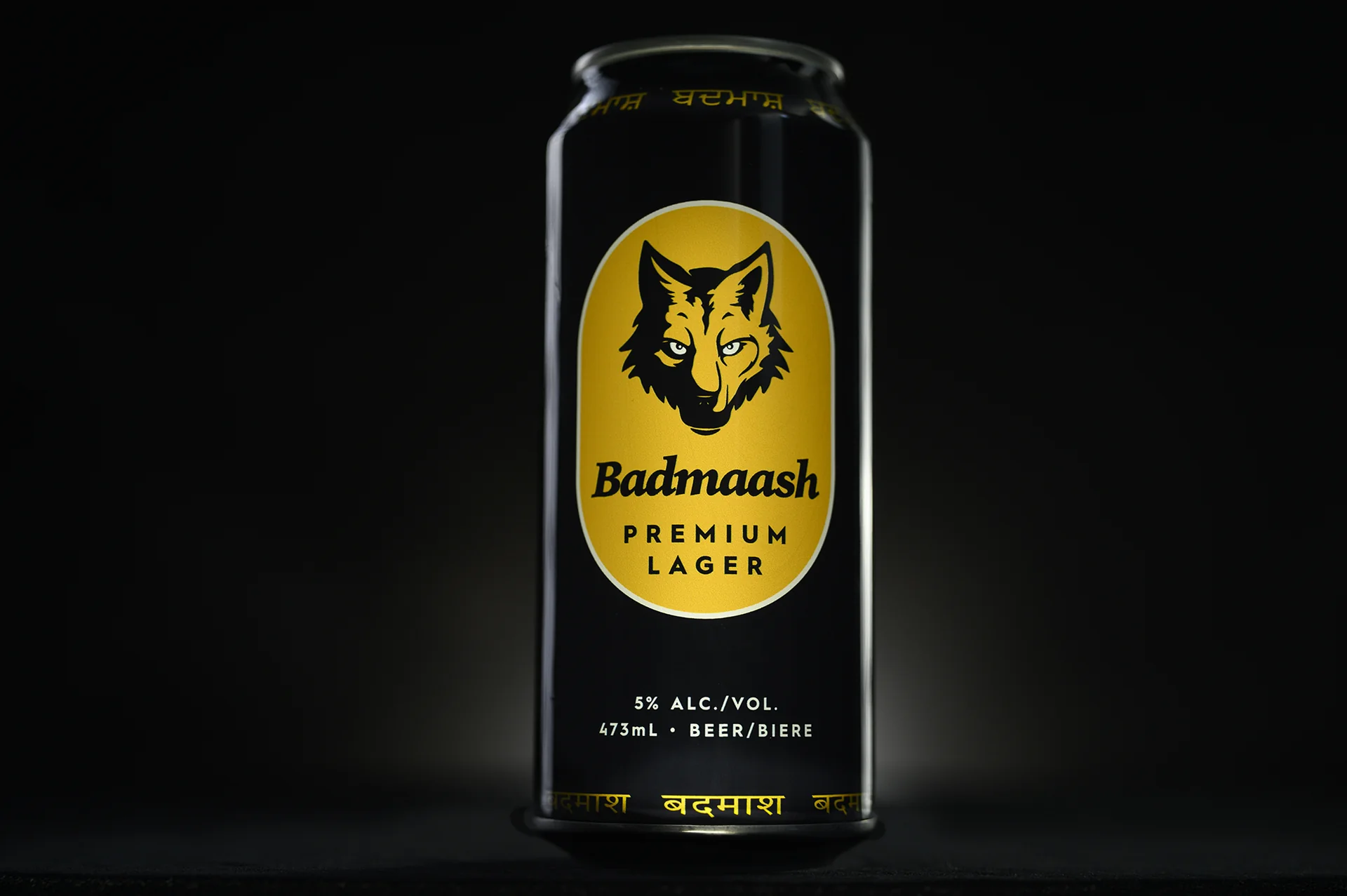Front of the Badmaash Premium Lager can: wolf crest, gold script logo, Premium Lager, 5% alc./vol., 473 mL
